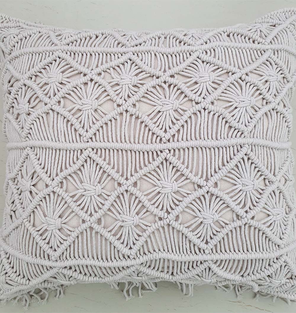 The RAMSHA HOME Cotton Cushion CS-276 features an intricate off-white macramé cover with geometric diamond and star patterns, finished with fringe edges—a handmade decorative accent for your home.