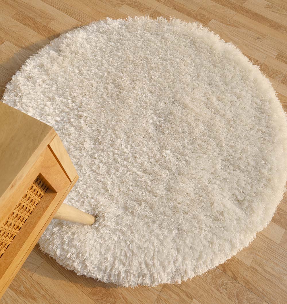 The RAMSHA HOME Decorative Shaggy Rug White Color - SG-012 features a round, plush design with thick pile, adding cozy comfort and modern style to any light wood floor next to furniture with woven accents.