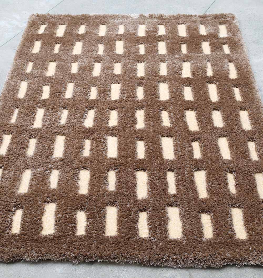 The RAMSHA HOME Modern Shaggy Rug For Living Room SG 015 (170x240 CM) is a rectangular brown rug with evenly spaced beige geometric shapes, ideal for placement on a light-colored floor.