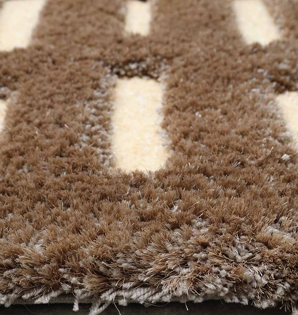 Close-up of the RAMSHA HOME Modern Shaggy Rug For Living Room SG 015 (170x240 CM), featuring brown fibers with a cream striped pattern. The soft texture brings cozy warmth and stylish comfort to any space.