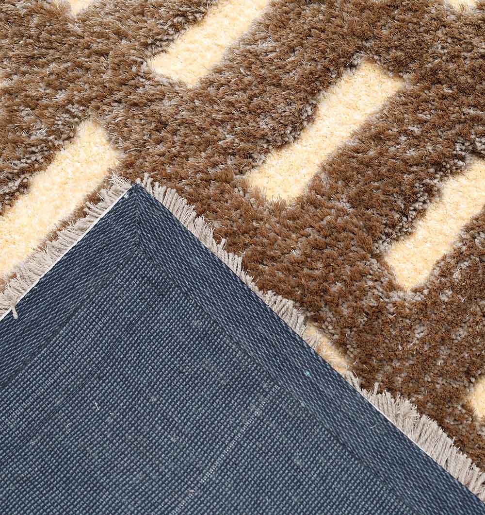 A close-up of the RAMSHA HOME Modern Shaggy Rug For Living Room SG 015 (170x240 CM) in brown and cream, with fringed edges and a textured front—its soft, neutral design adds warmth to any space.