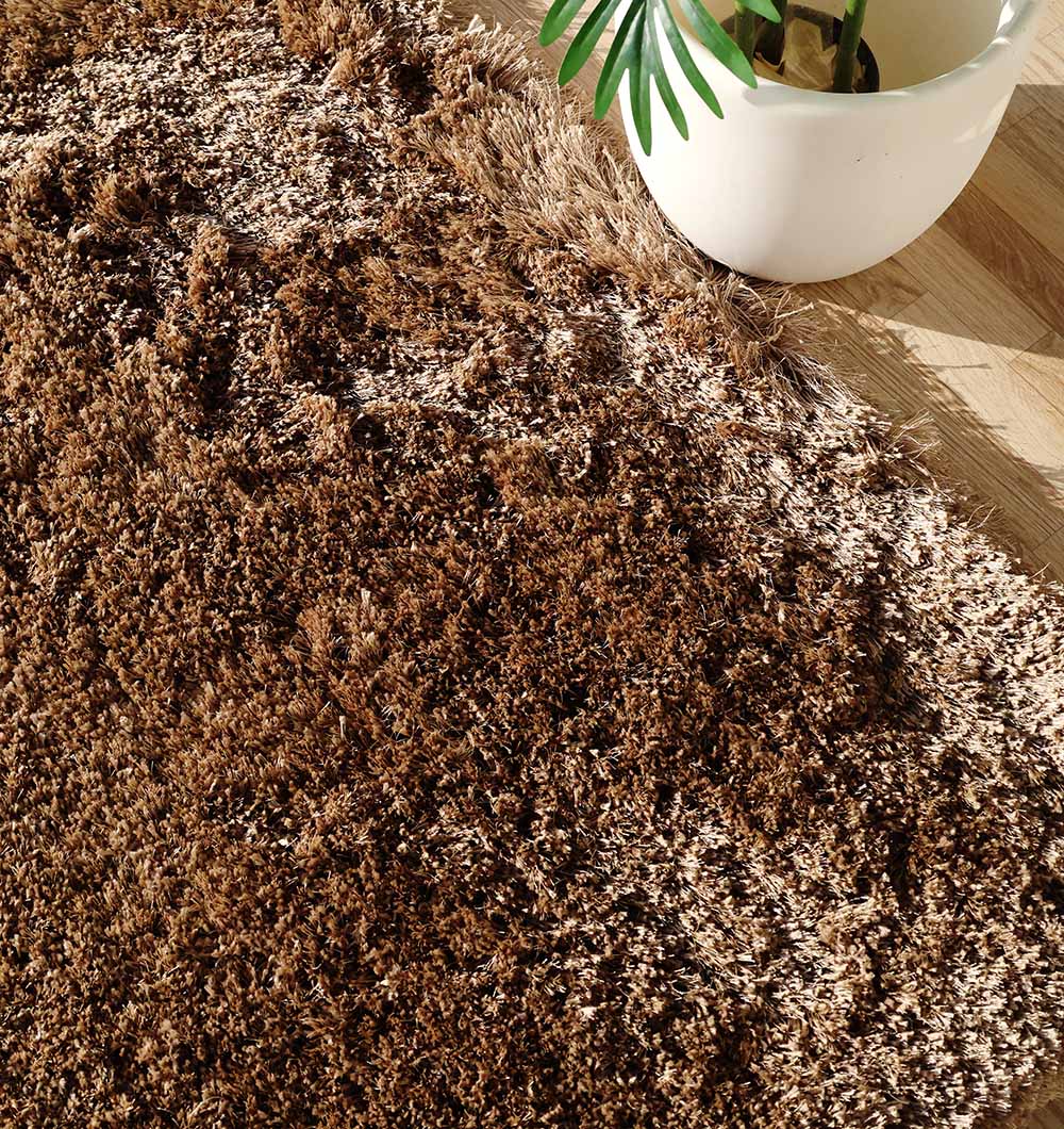 A close-up of the Premium Shaggy Rug for Ramadan Gifting - SG 025-A by RAMSHA HOME on a wooden floor, with a leafy green plant in a white pot. Sunlight casts soft shadows—perfect for your décor this Ramadan.