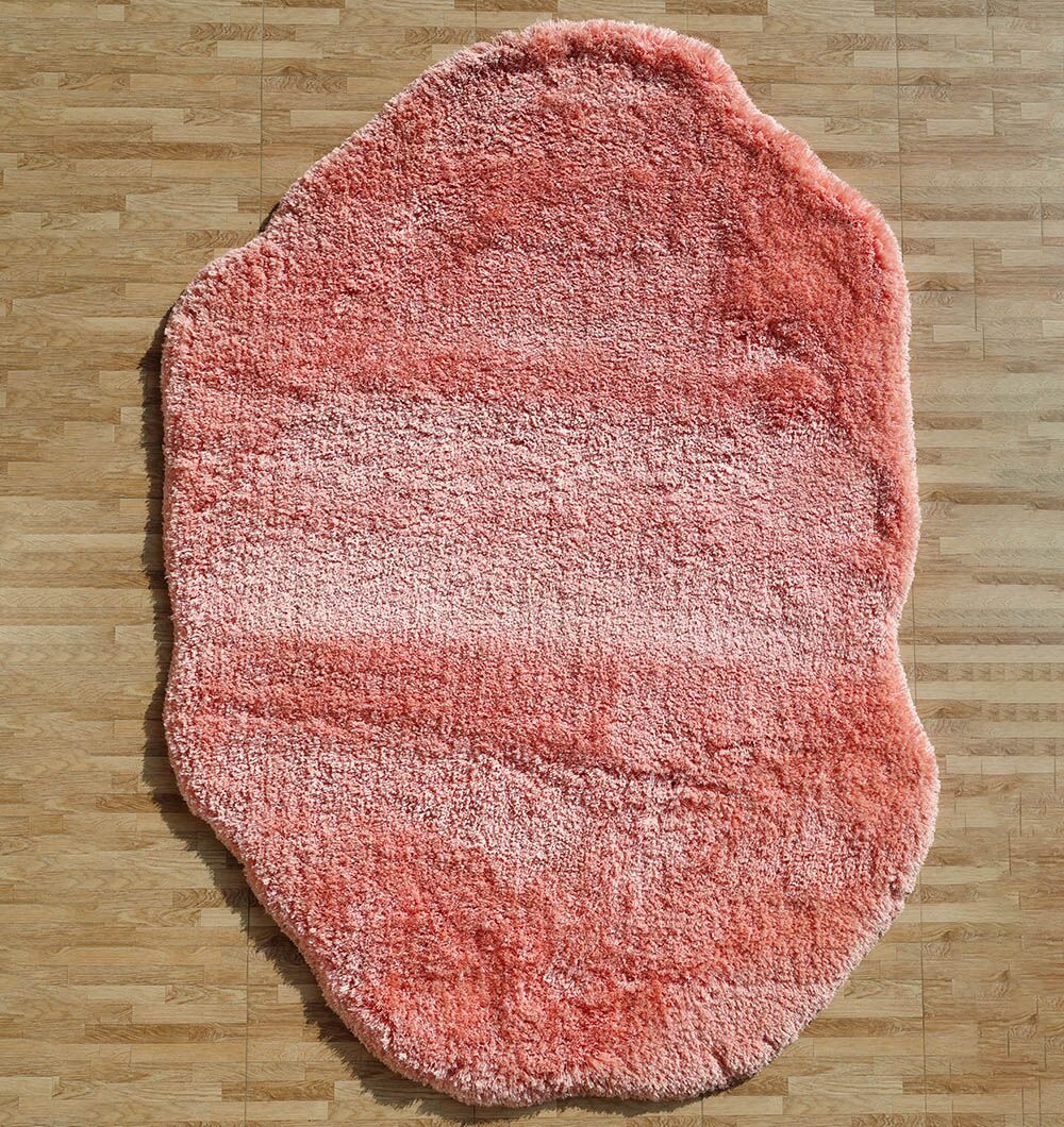 The RAMSHA HOME Shaggy Shape Rug for Living Room - SG 027-B (200x300 cm), with its pink tones and irregular shape, adds a soft, cozy touch to the light wood floor.