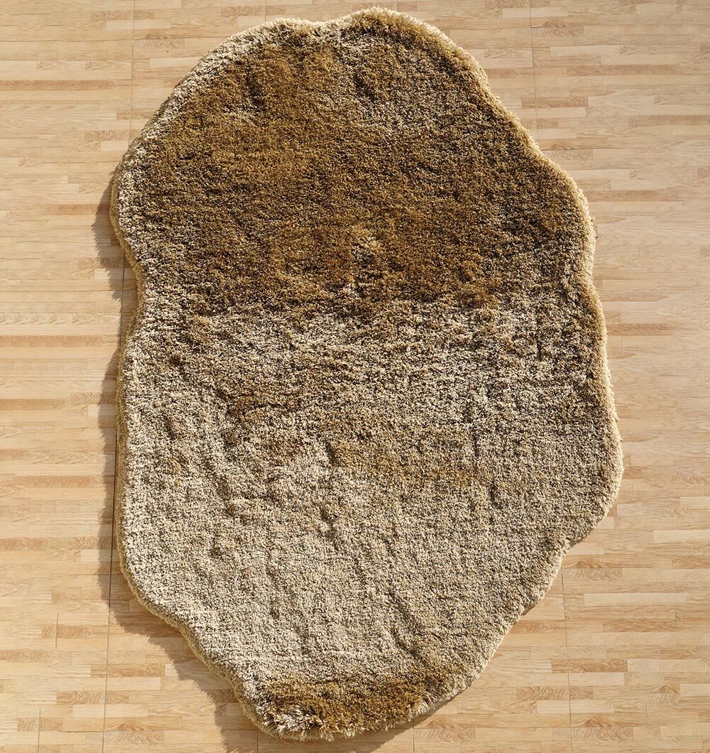 The RAMSHA HOME Large Beige Shaggy Shape Rug for Living Room - SG 030 (200x300 cm) features a unique, irregular form and soft beige tones, creating a cozy accent on the light wood floor that resembles the shape of a potato.