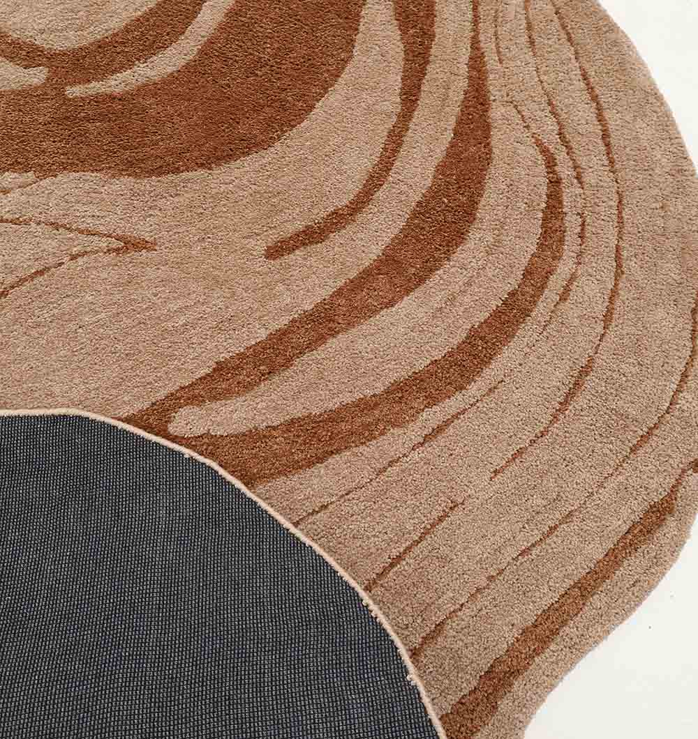 The RAMSHA HOME Shaped Rug Beige & Brown Color Shaggy Rug for Living Room - SG 033 (160x230 cm) features abstract swirling designs and is displayed beside dark gray textured flooring.