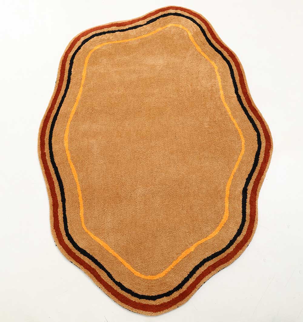 The RAMSHA HOME Shaped Rug Multi Color Shaggy Rug for Living Room - SG 035 (160x230 cm) features a tan, irregular shape with wavy edges and concentric brown, black, and orange borders, shown on a white background.