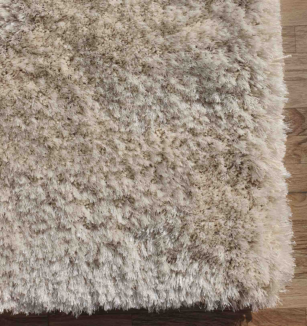 Close-up of the RAMSHA HOME Gold Color Shaggy Area Rug for Large Living Room (SG 03 B) on a wooden floor, highlighting its soft, plush fibers and dense texture that create a cozy atmosphere.