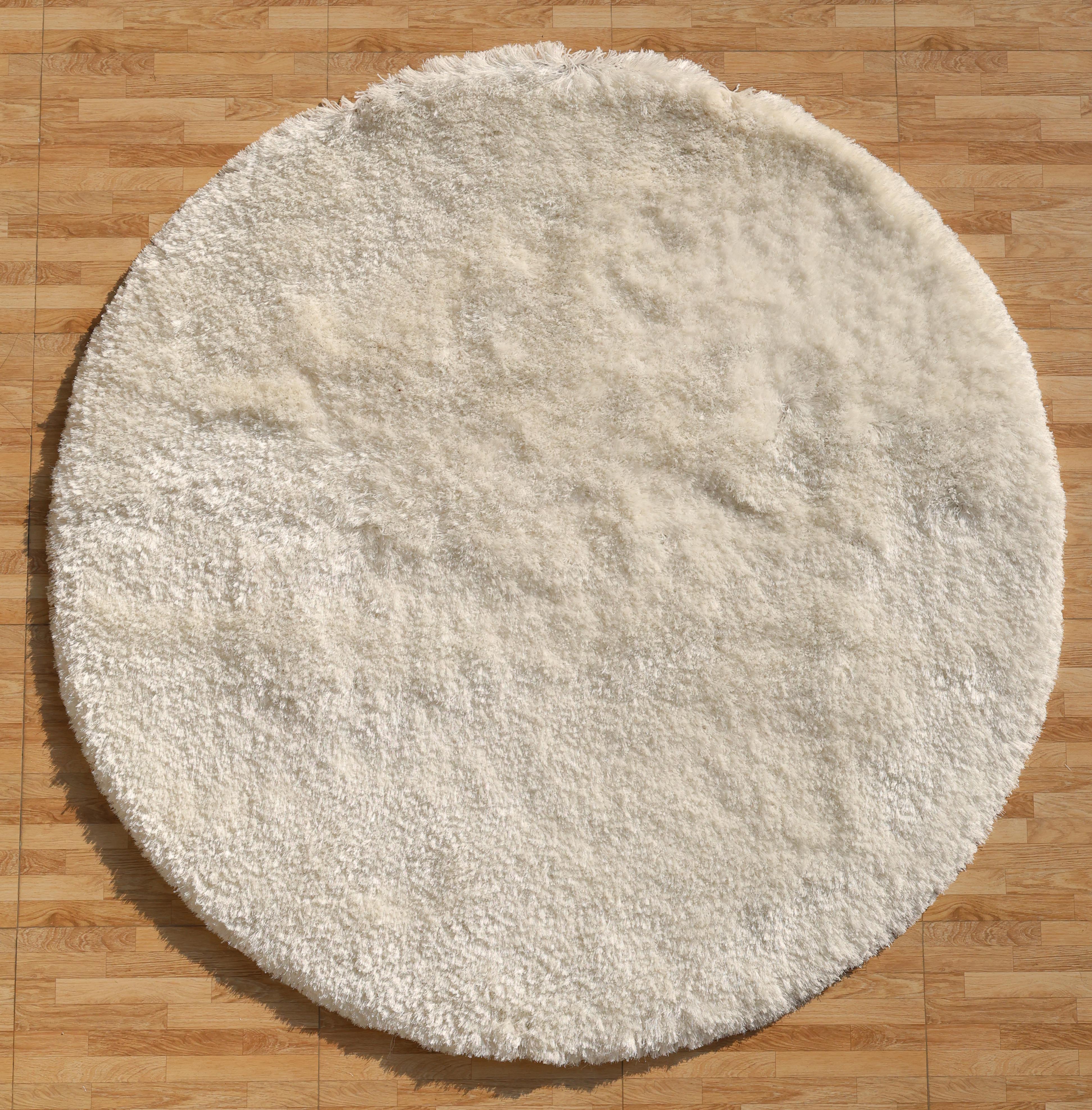 The RAMSHA HOME White Color Plush Shaggy Area Rug - SG 040 with soft, fluffy fibers adds cozy texture and warmth to any light brown wooden floor.