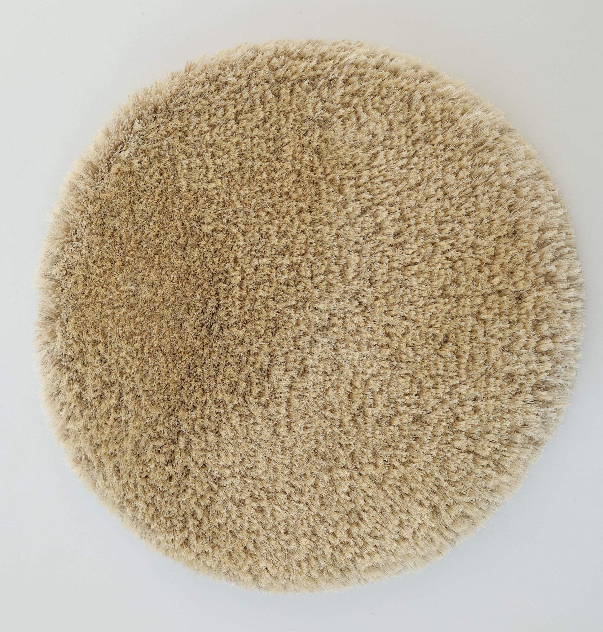 The RAMSHA HOME Modern Ultra Soft Shaggy Carpet for Bedroom - SG 041 is a plush, round beige rug with a cozy feel, photographed from above on a white background—ideal for adding warmth to any modern interior.