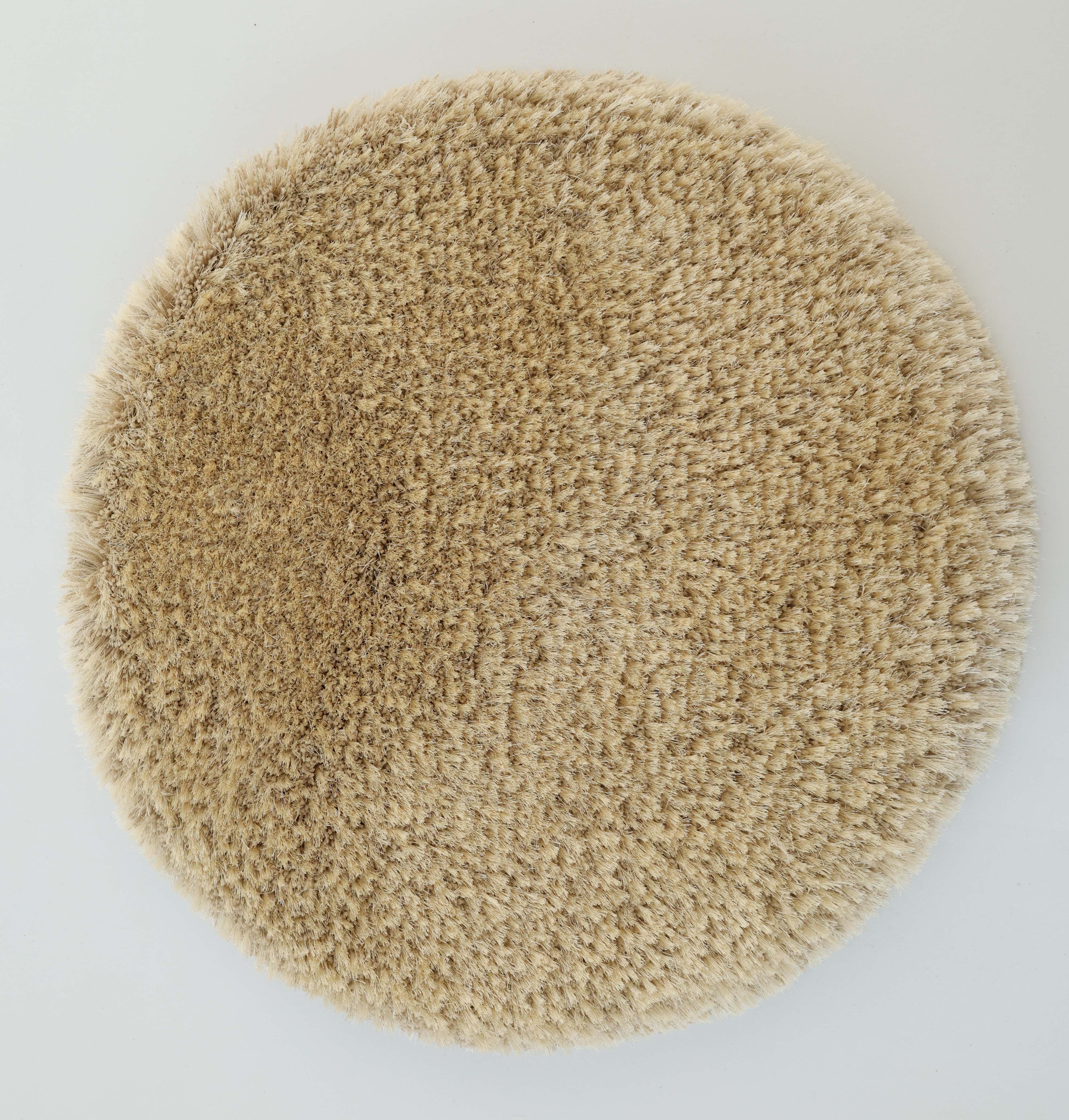 The RAMSHA HOME Modern Ultra Soft Shaggy Carpet for Bedroom - SG 041 is a plush, round beige rug with a cozy feel, photographed from above on a white background—ideal for adding warmth to any modern interior.