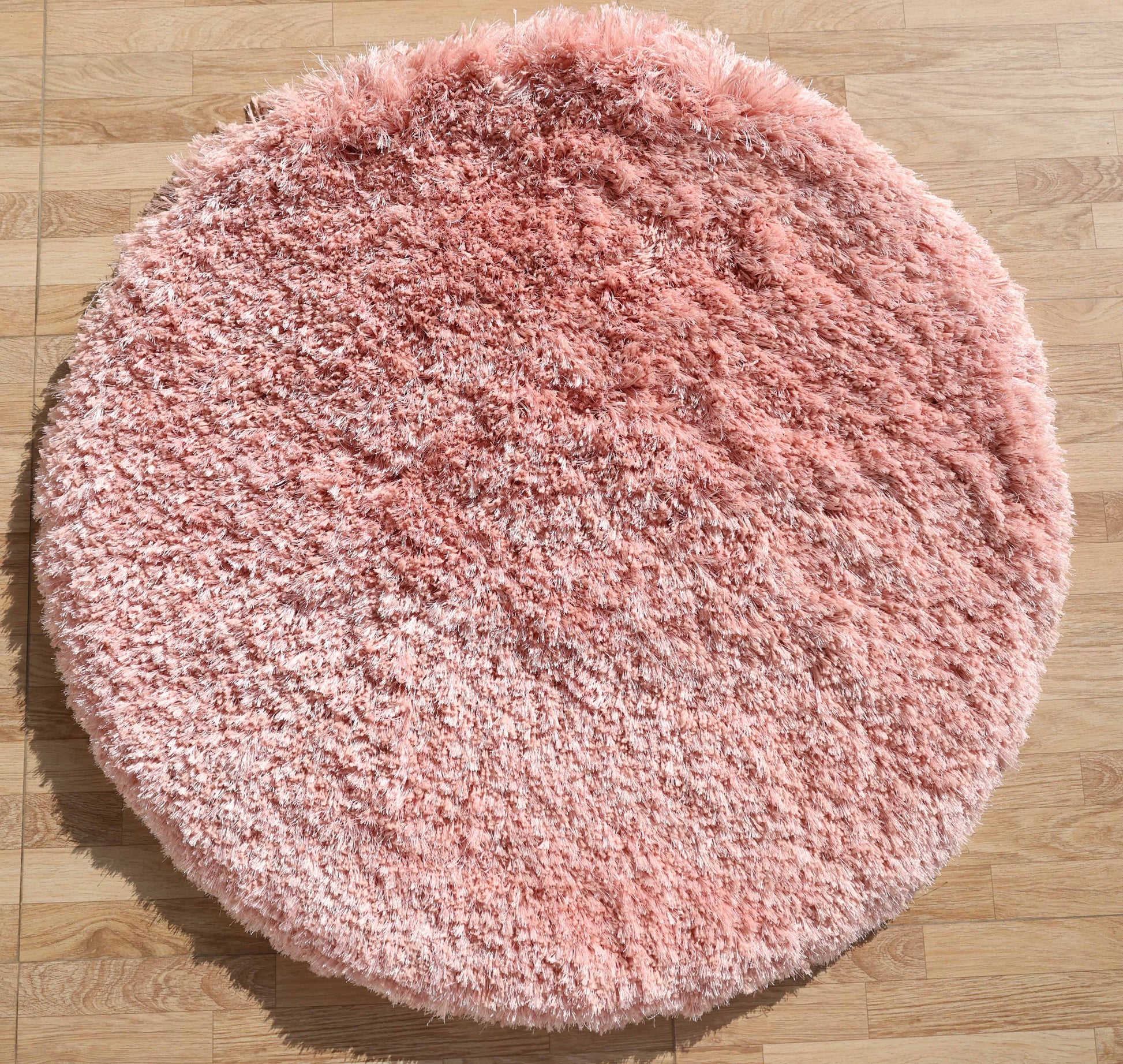 The RAMSHA HOME Modern Ultra Soft Pink Shaggy Carpet for Bedroom (SG 042) adds a cozy, plush accent to light wood floors, making it an ideal choice for modern interiors with its fluffy texture and stylish design.