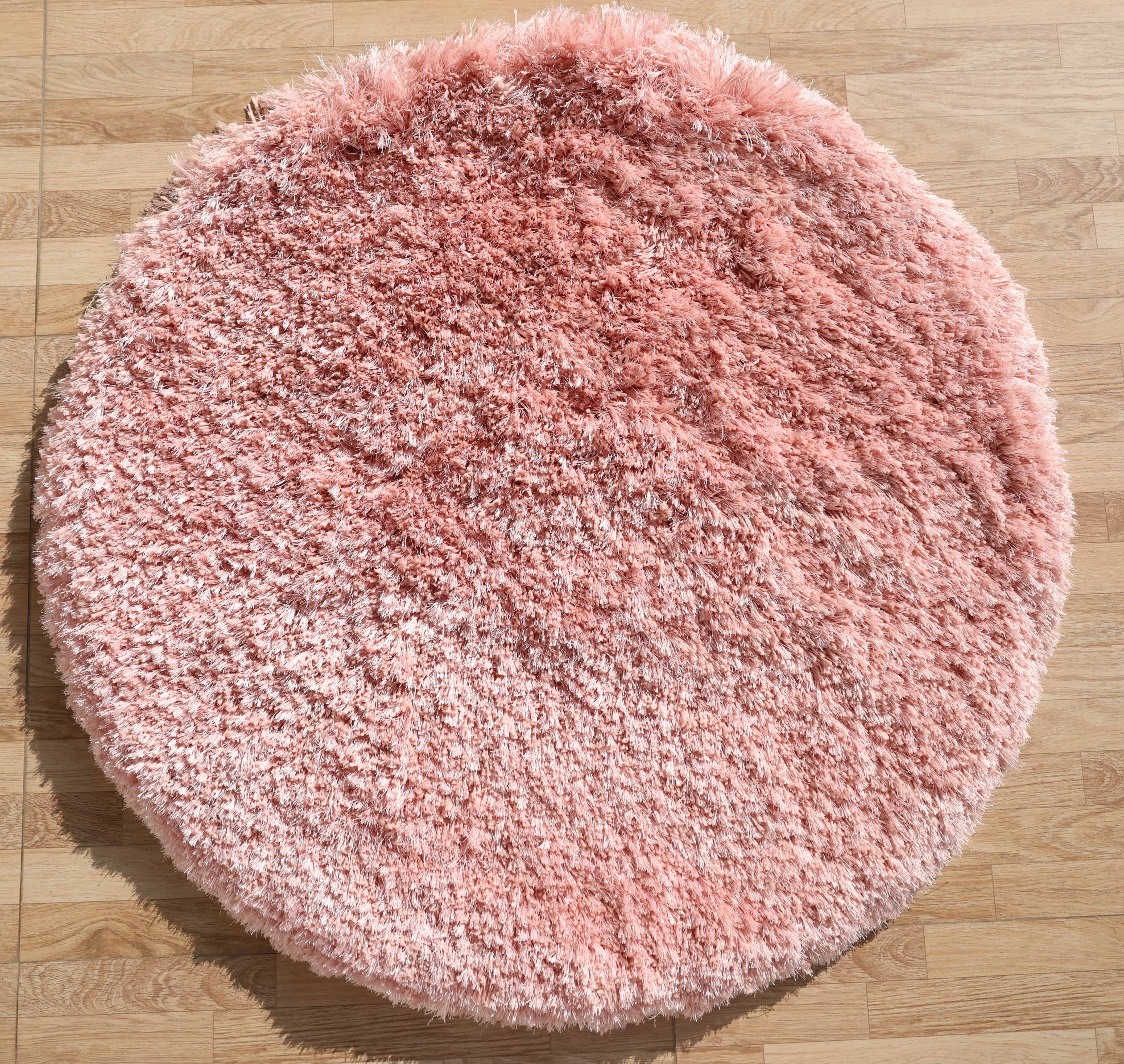 The RAMSHA HOME Modern Ultra Soft Pink Shaggy Carpet for Bedroom (SG 042) adds a cozy, plush accent to light wood floors, making it an ideal choice for modern interiors with its fluffy texture and stylish design.