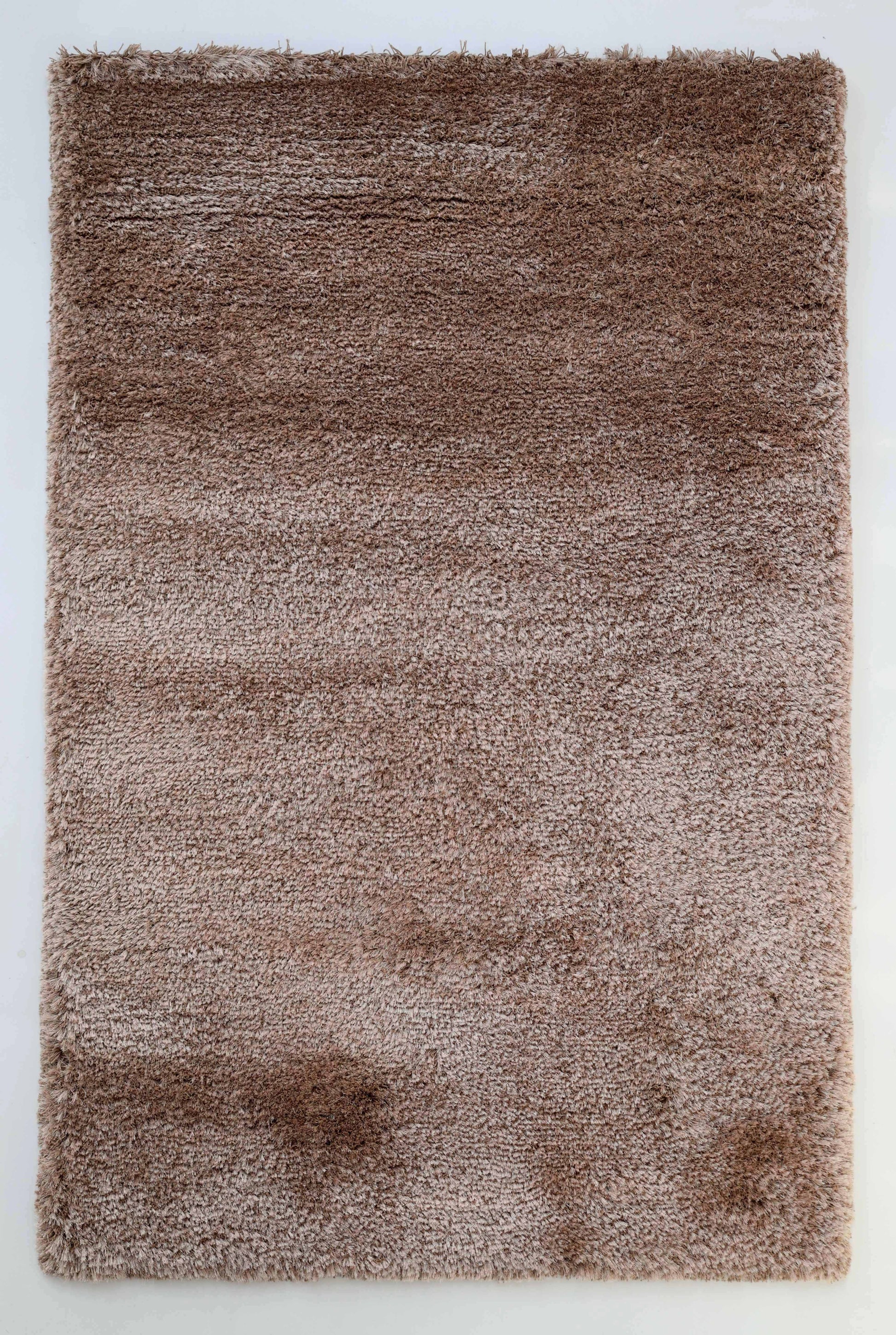 The RAMSHA HOME Soft Plush Brown Shaggy Rug for Living Room (SG 043) features a cozy, textured surface and is displayed on a white background, highlighting its modern comfort and plush style.