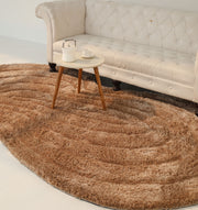 A beige tufted sofa sits behind a small round table with a white teapot and cup, placed on the RAMSHA HOME Luxury Soft Touch Irregular Shaggy Area Rug - SG 043 3D in a bright, minimalist room.