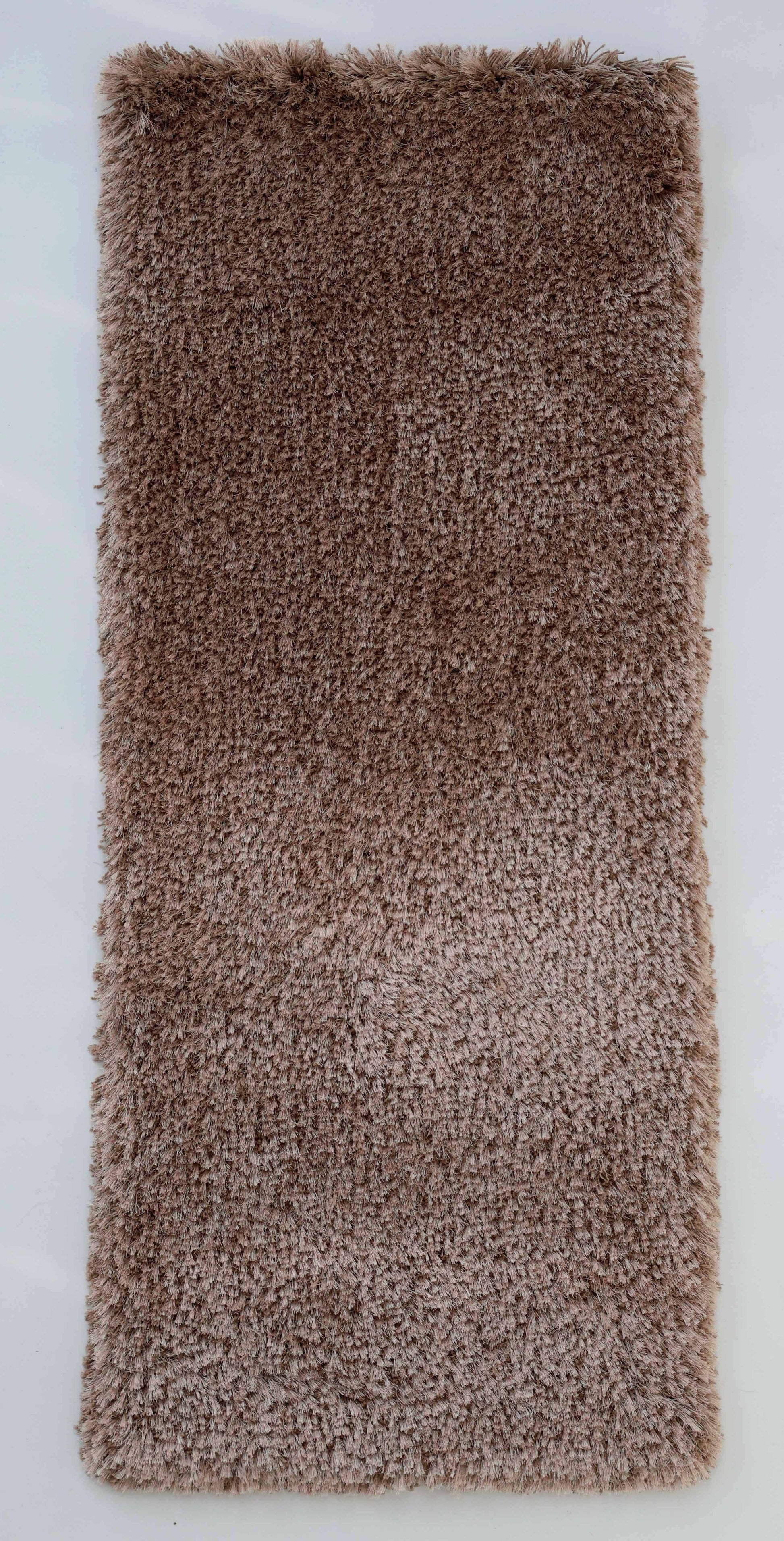 The RAMSHA HOME Soft Plush Brown Shaggy Rug for Living Room - SG 043 is a rectangular rug with a soft, fluffy texture, displayed against a white background.