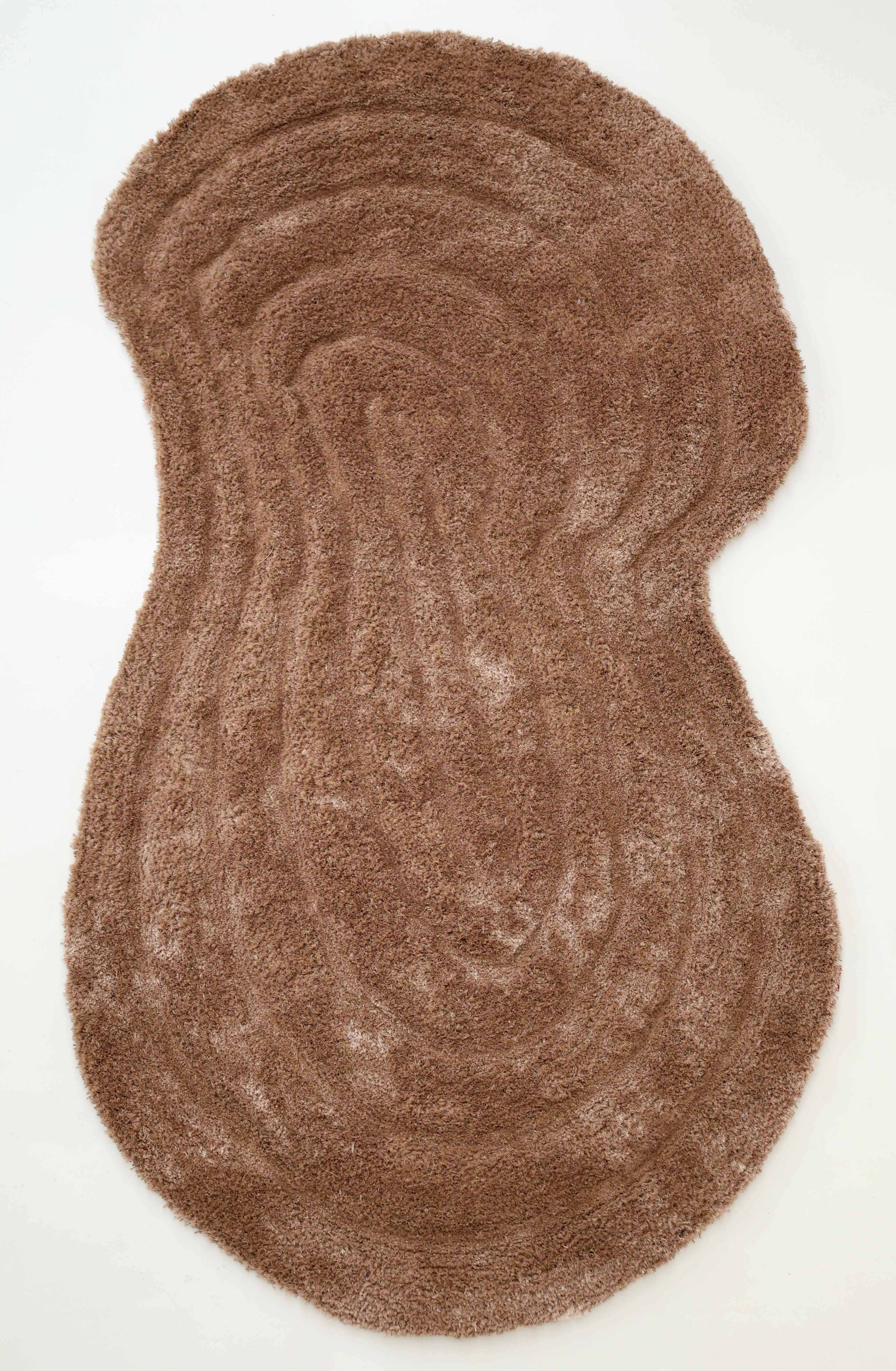 The RAMSHA HOME Luxury Soft Touch Irregular Shaggy Area Rug - SG 043 3D features a curved, abstract brown design with a textured surface and organic, topographic-inspired irregular shape, shown on a white background.
