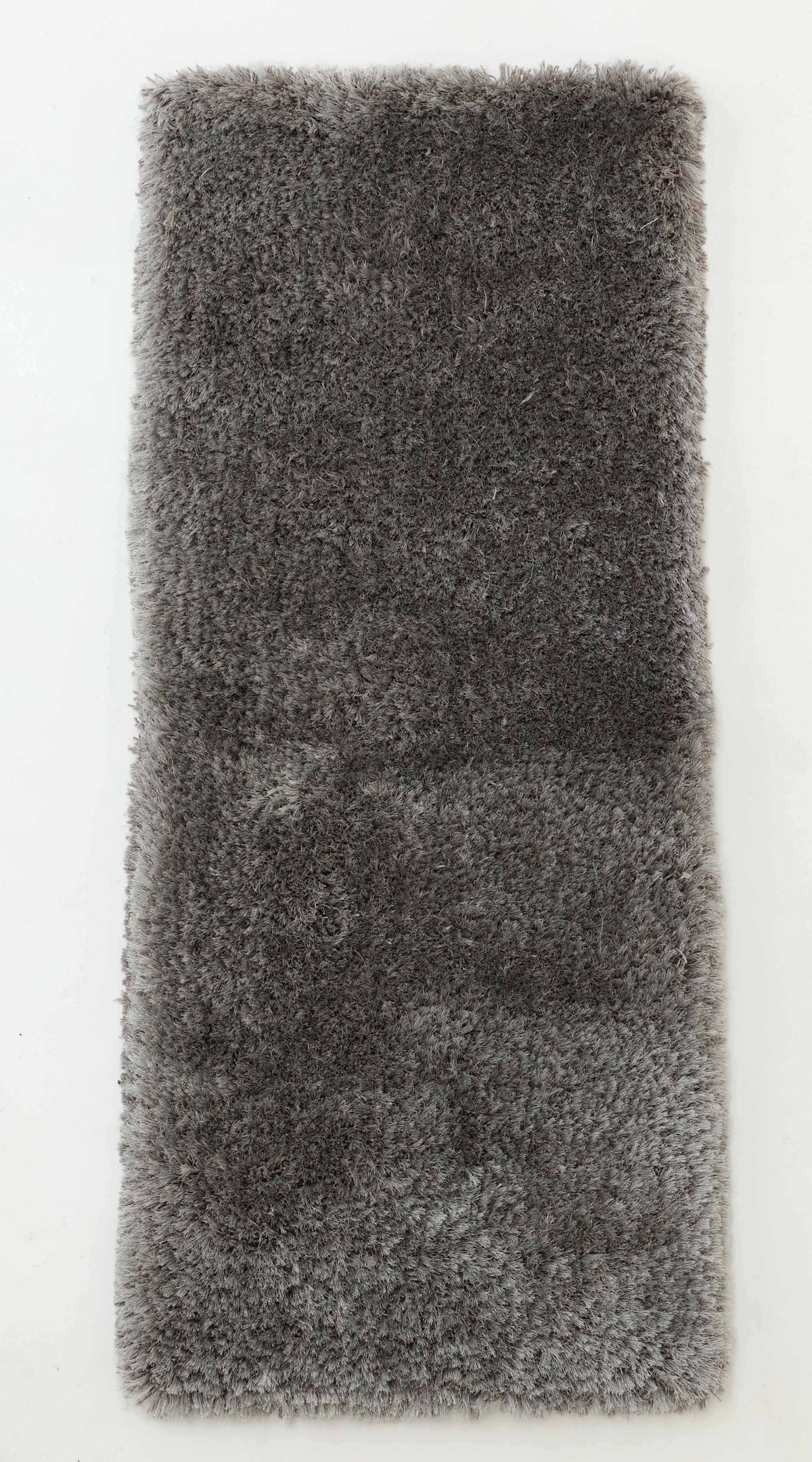 The RAMSHA HOME Soft Plush Grey Shaggy Rug for Living Room - SG 044, with its soothing gray tone and luxuriously fluffy texture, is displayed on a plain white surface.