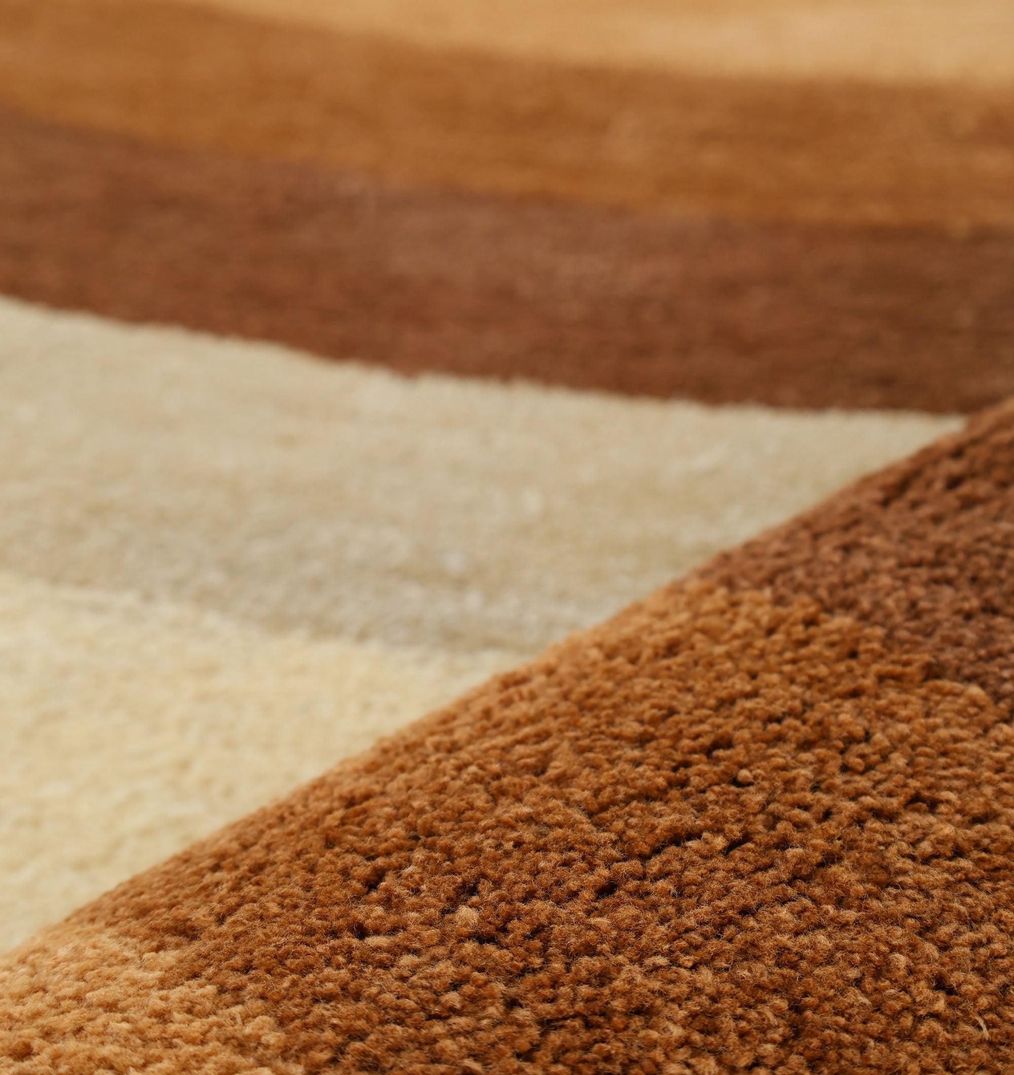 Close-up of the RAMSHA HOME Modern Beige & Brown Circular Shaggy Rug (SG 053), featuring wavy stripes in various brown, tan, and beige shades—perfect for a living room.