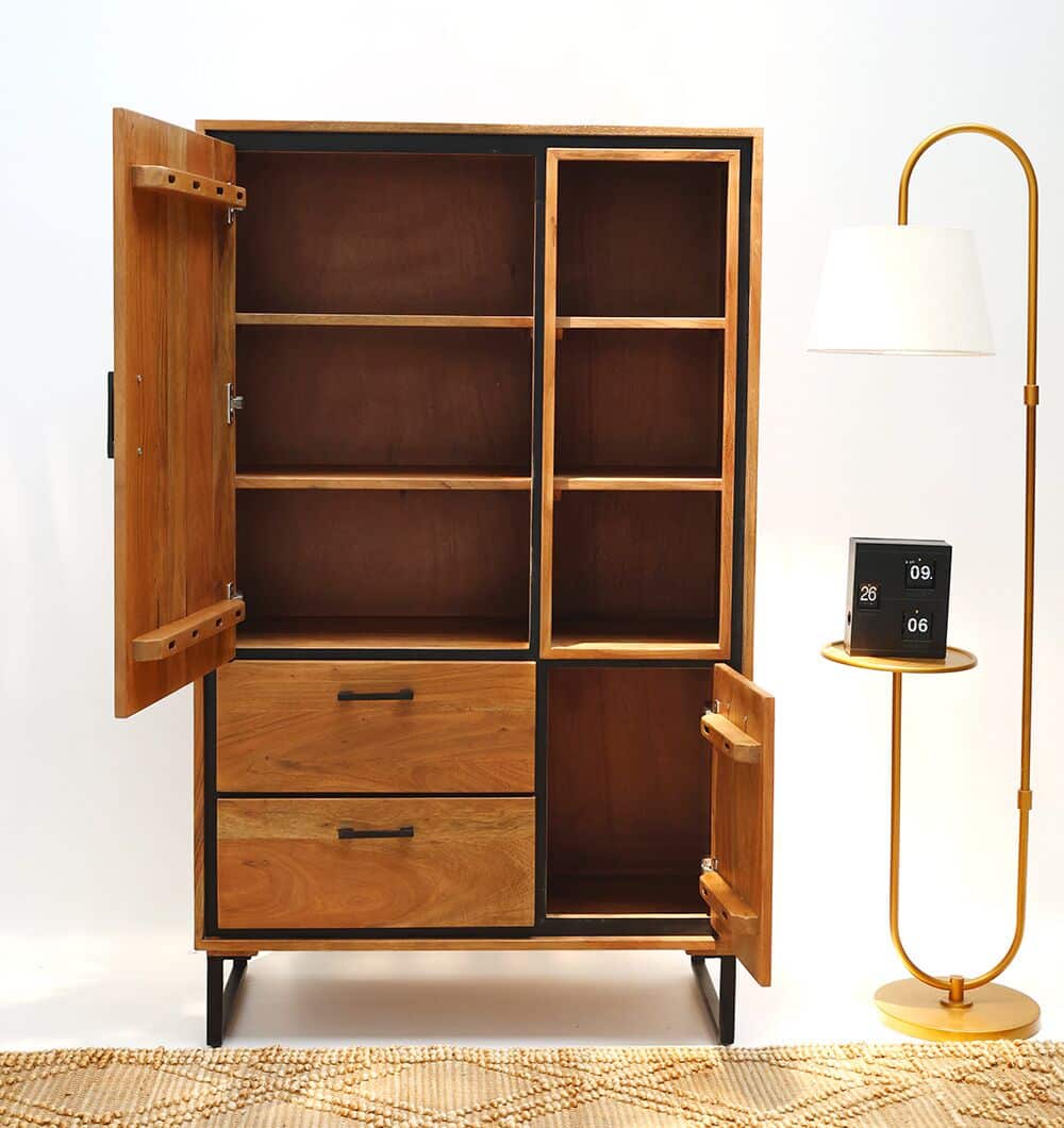 The RAMSHA HOME Handcrafted Acacia Wood Cabinet Almirah with open shelves stands in the living room next to a modern floor lamp with a white shade and a small round table holding a black digital clock, set on a patterned rug.