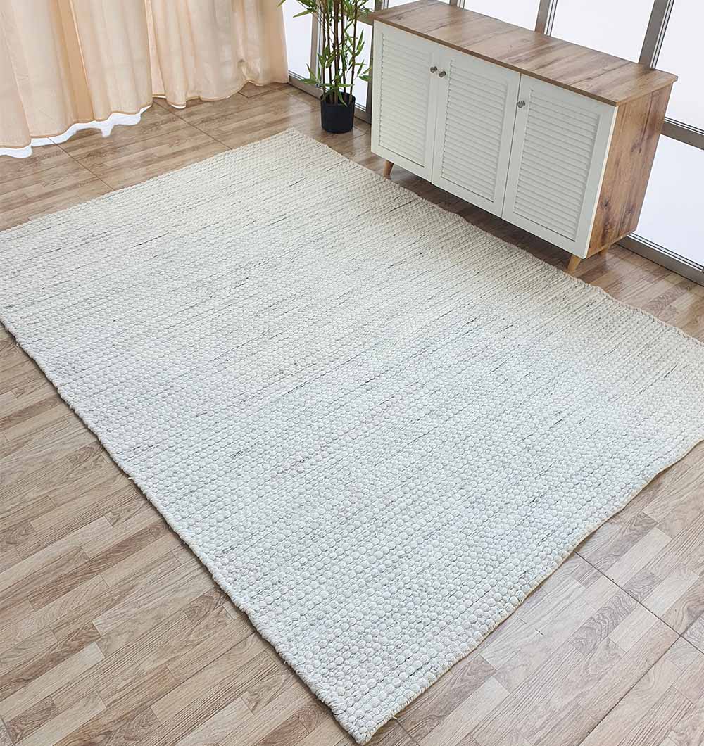 Side angle view of the rectangular PET woven rug in a living space, showcasing its long-lasting durability in a high-traffic area.