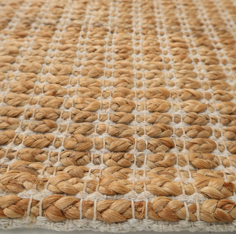 Close-up of the Handmade Natural Color Hand Woven Area Rug SR-062 by RAMSHA HOME, showcasing its thick, braided texture with detailed fiber interlacing in natural beige and off-white—ideal for artisanal home décor.