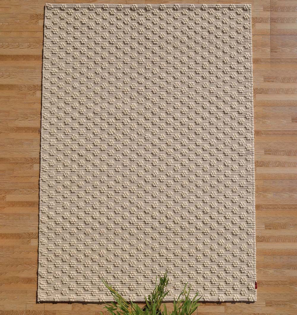 Handmade woven area rug in a natural color palette, offering remarkable adaptability for any home decor style.