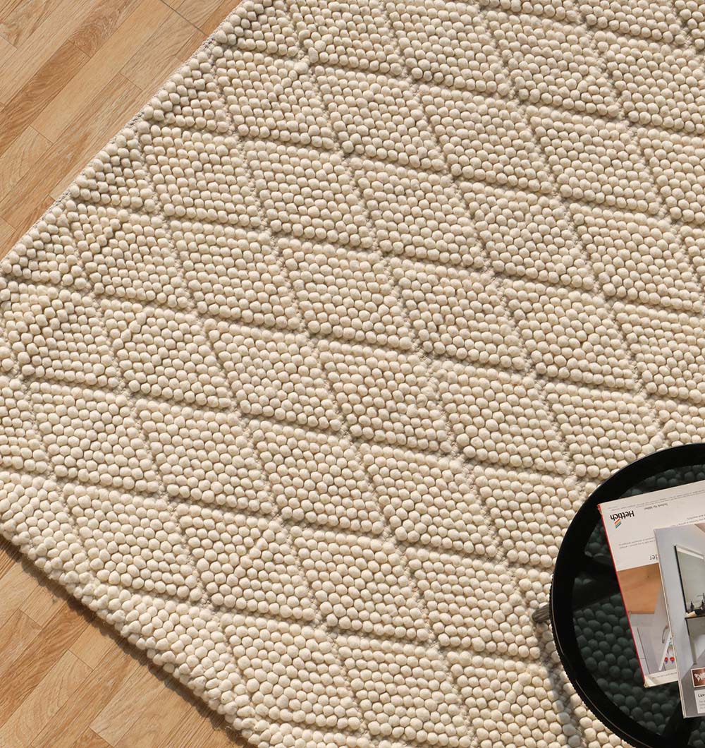 Handmade rug placed in a bedroom, offering refined aesthetics and timeless elegance to the interior design scheme.