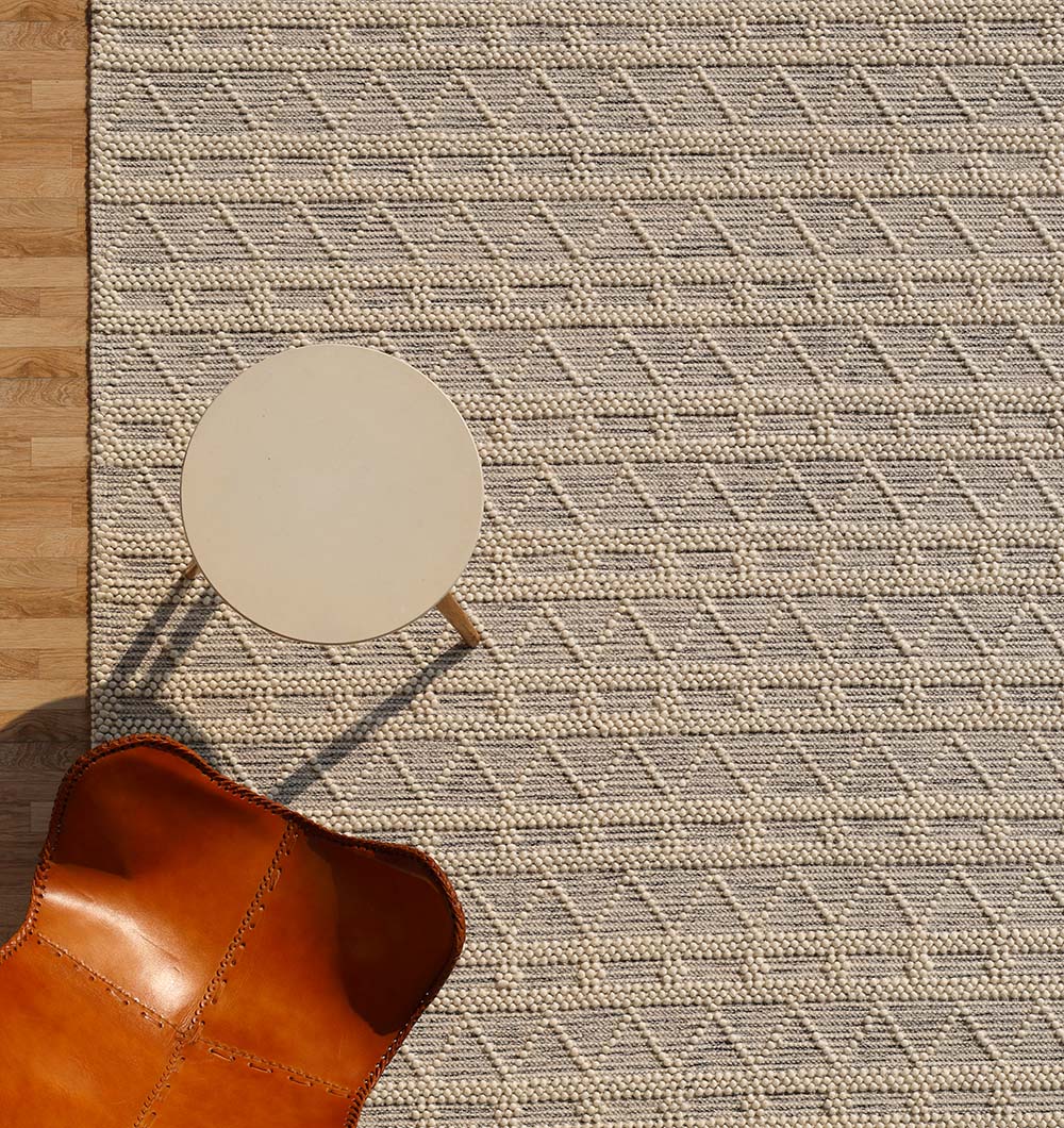 Angled view of the handmade rectangle rug, providing warmth and texture that withstands daily foot traffic.