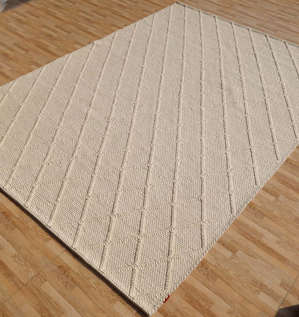 Angled view of the hand-woven floor covering, highlighting its flexibility and rich texture.