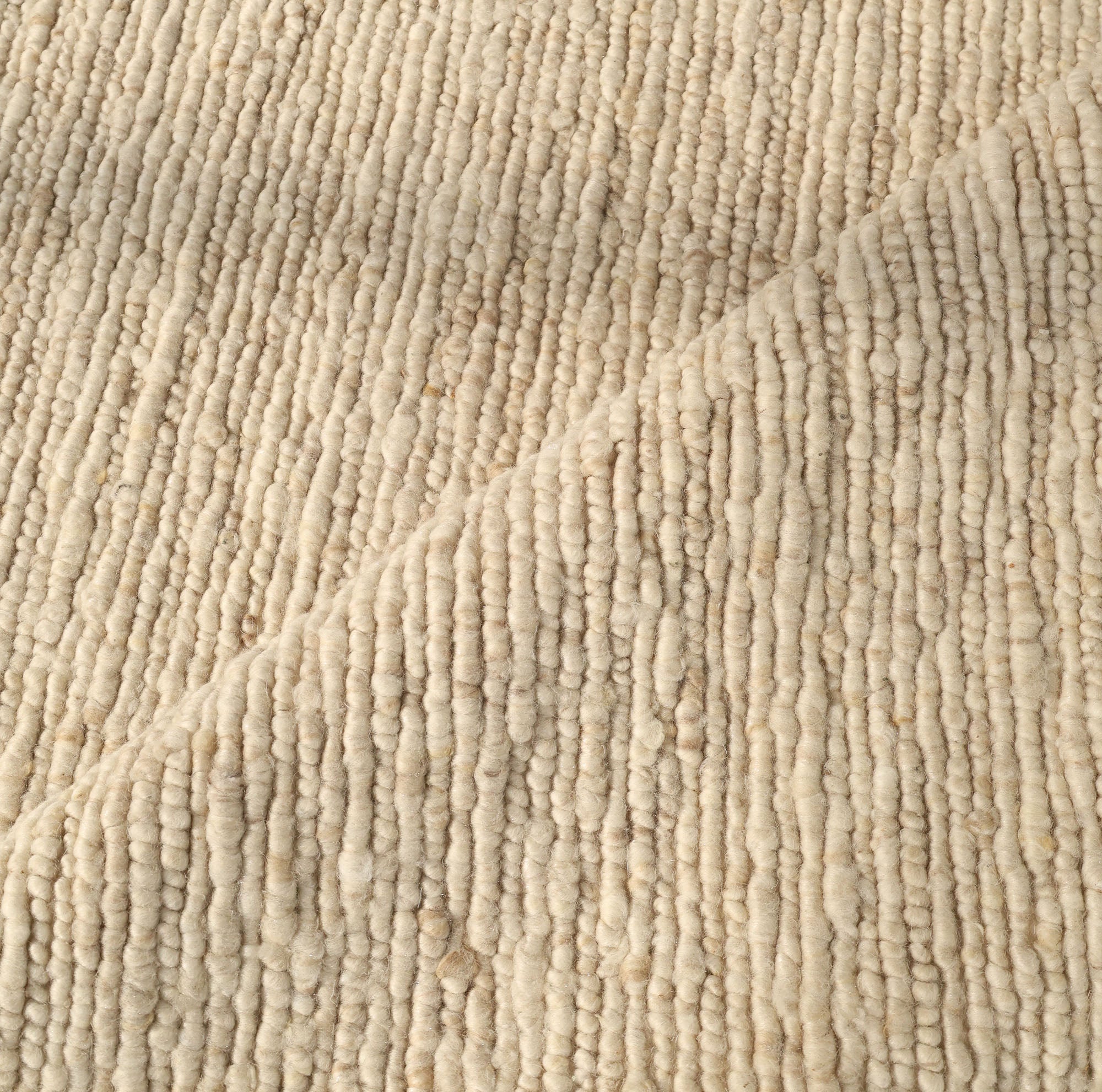 Close-up of the Earthy Blush Contemporary Flatweave Rug (SRN-044) by RAMSHA HOME, showcasing its beige, textured woven pattern with subtle horizontal rows and a central diagonal fold—highlighting soft, natural fibers and artisanal craftsmanship.