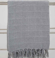 The Ramsha Home Living Room Throw Light Grey Color TAL 054 (130x160cm) adds a subtle checkered touch and cozy fringed edges to your décor—ideal for draping on sofas or towel racks.