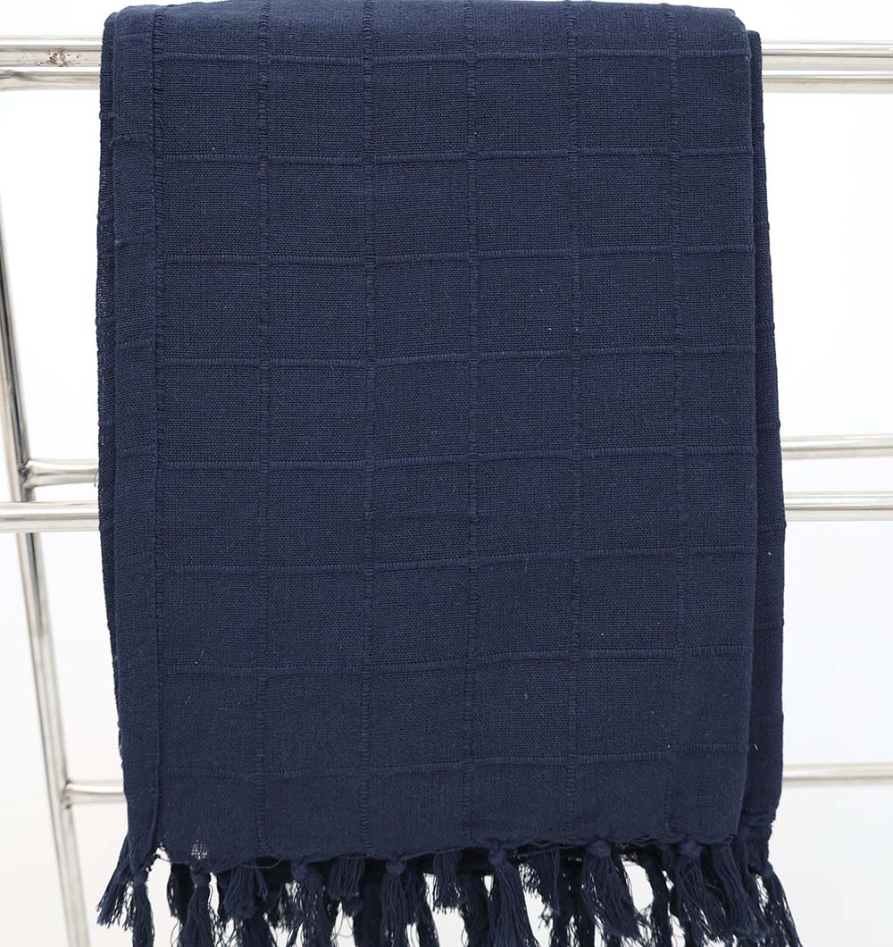 The Ramsha Home Living Room Throw in Navy Blue (TAL 055, 130x160cm) with a subtle grid pattern and fringed edges is displayed over a silver rack against a white background, bringing luxurious elegance to any space.