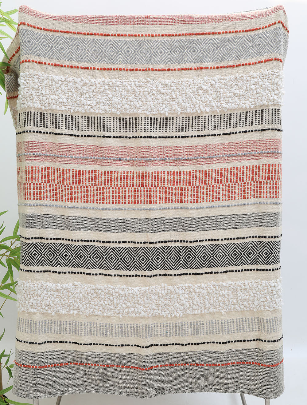 The Ramsha Home Living Room Throw Multi Color TAL 058 (130x160 cm) features cream, gray, black, and red stripes with solid, dotted, and geometric patterns—an elegant accent for your living room decor.