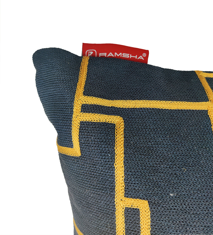 A close-up of the Black And Yellow Embroidery Cotton Cushion CS-261, featuring a yellow geometric pattern and a RAMSHA HOME red fabric tag at the top edge.
