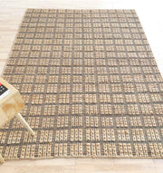 Handcrafted Jute area rug providing a grounded foundation and practical functionality in a cozy living space.