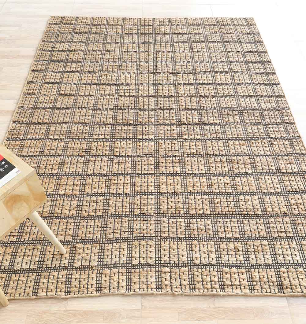 Handcrafted Jute area rug providing a grounded foundation and practical functionality in a cozy living space.