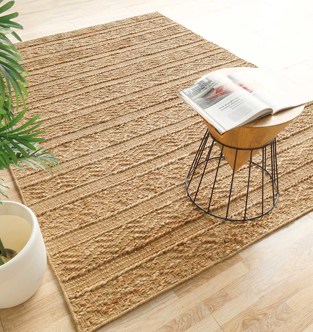 Natural color jute area rug with outstanding resilience, anchoring a spacious, well-lit residential application.