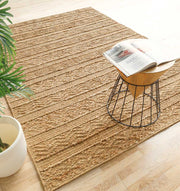 Natural color jute area rug with outstanding resilience, anchoring a spacious, well-lit residential application.