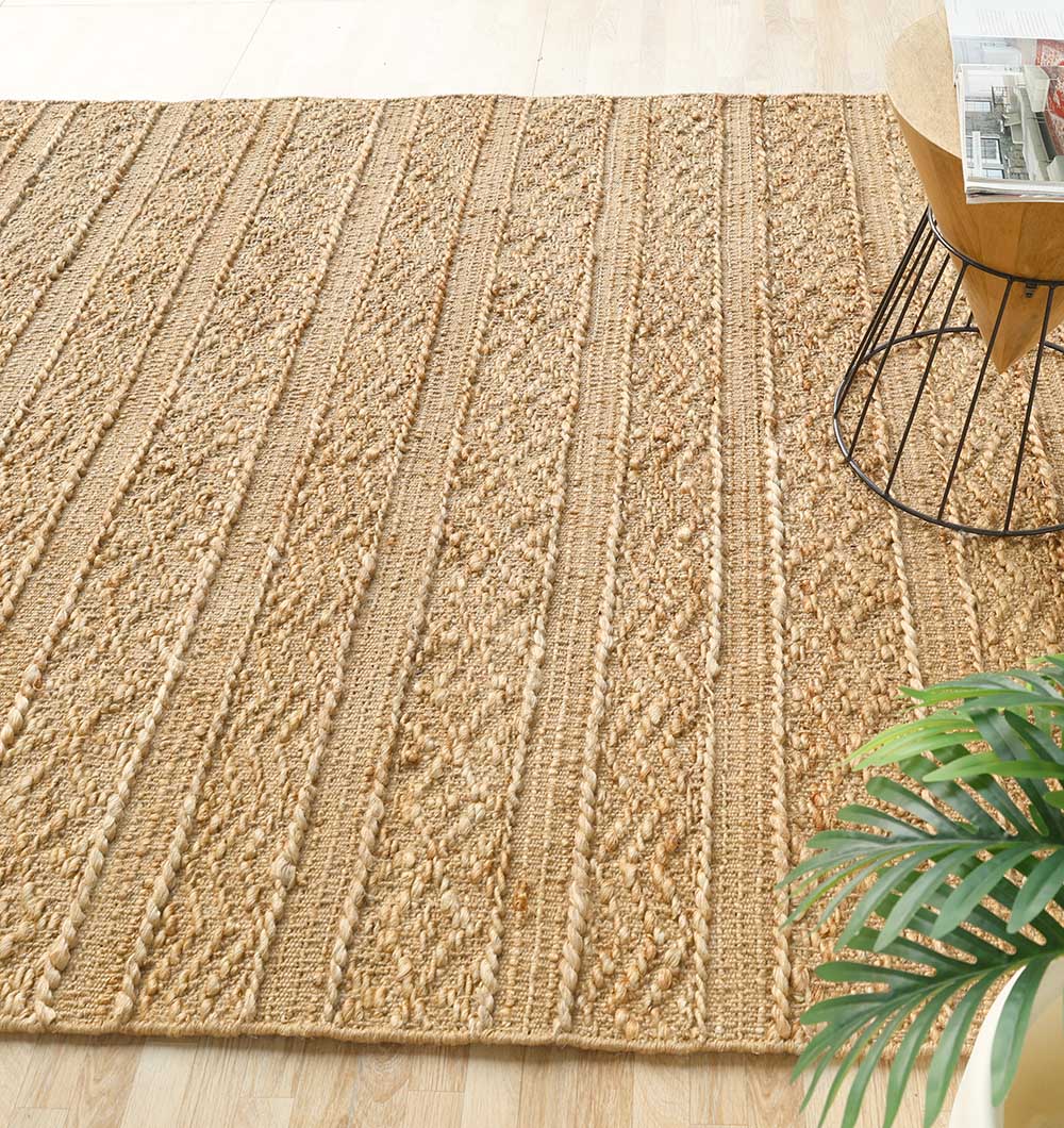 Angled view of the hand-woven rug, blending high-quality jute and refined elegance into the interior space.