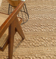Close-up of the tightly woven jute pattern, reflecting meticulous craftsmanship and natural warmth.
