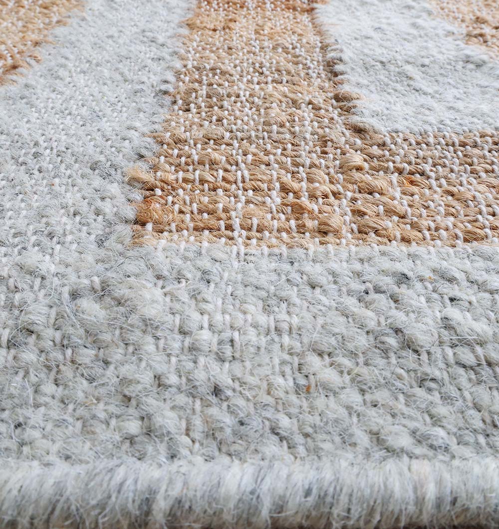 Close-up of the RAMSHA HOME Decorative Woven Rug For Living Room WR-038, showing thick beige and light gray stripes, detailed stitching, and a soft chunky surface—ideal as a cozy geometric border rug.