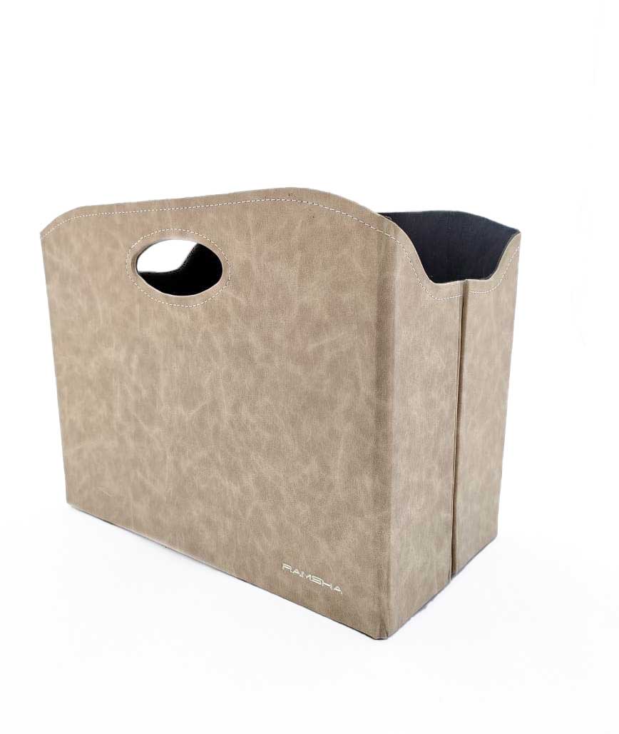 The Ivory Handmade Polyester Basket - BK 003 (35x20x27cm) by Ramsha Home features a tan rectangular design with faux leather finish, curved top edges, and oval cutout handles—ideal for home organization and décor.