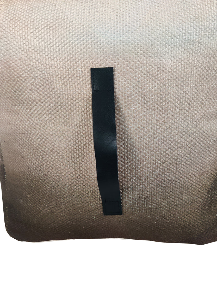 Close-up of brown pouf showing soft wool-cotton woven texture