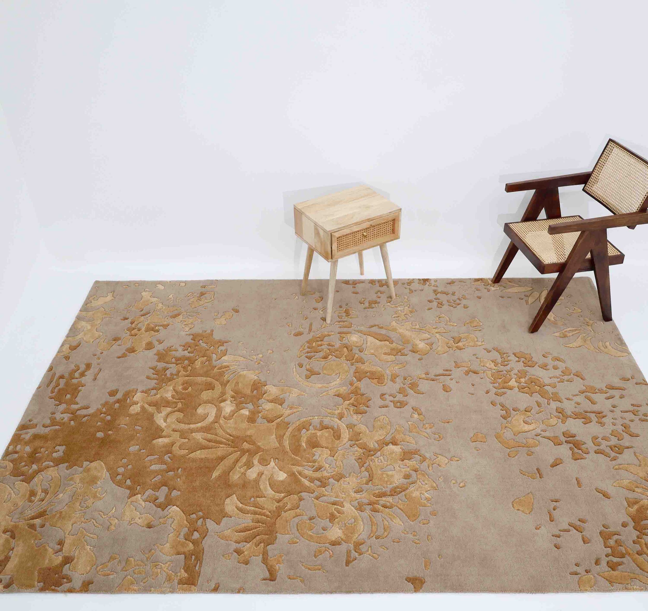 A modern room featuring the RAMSHA HOME Luxurious Rectangle Multi Color Novara Rug- CMN 21 (200x300cm), a small wooden table, and a cane-back wooden chair, all set against a plain white background.
