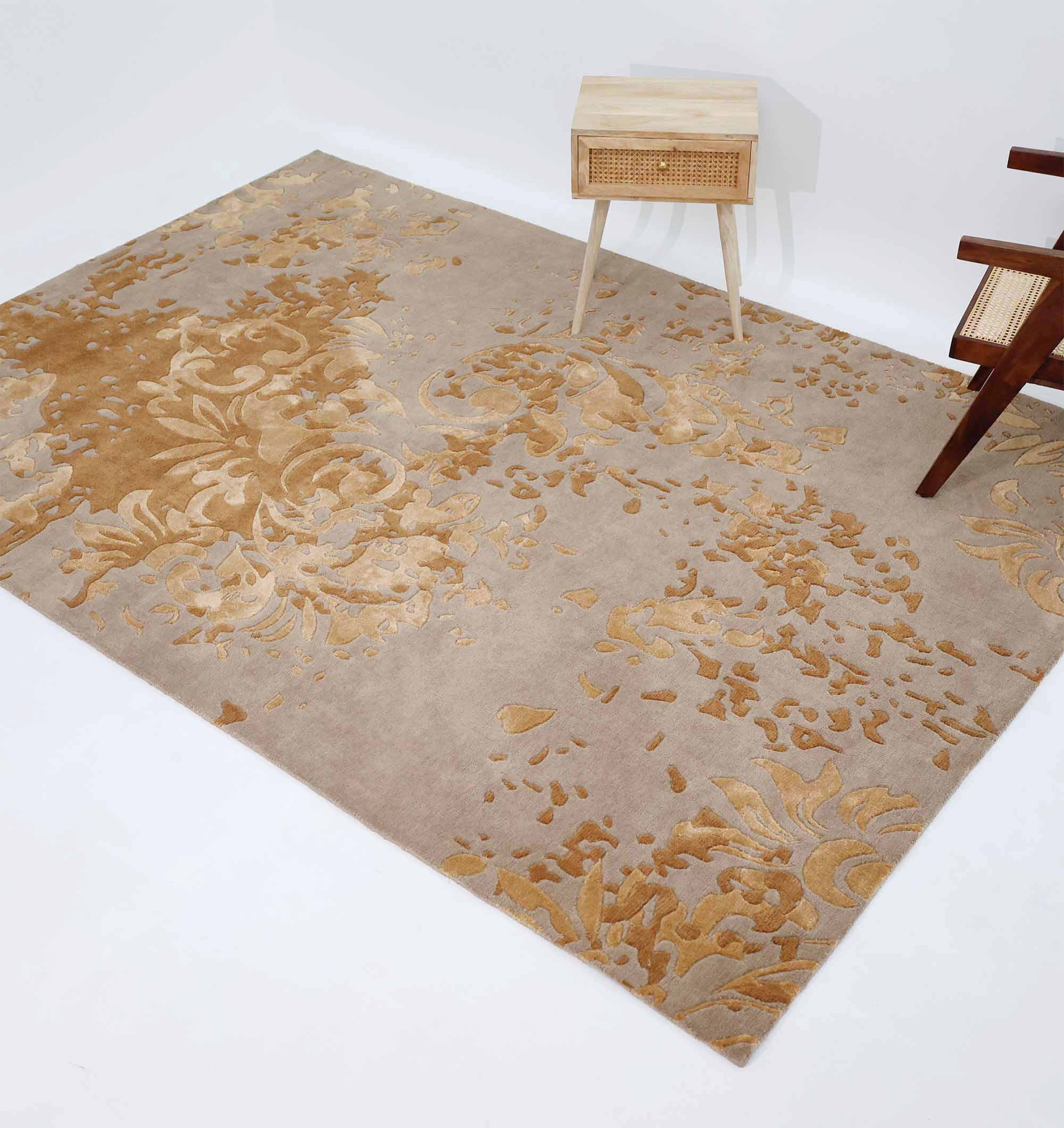 The RAMSHA HOME Luxurious Rectangle Multi Color Novara Rug- CMN 21 (200x300cm) is displayed on the floor beside a small wooden side table and chair, set against a white wall.