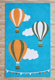 The RAMSHA HOME Kids Play Rug with Clouds & Balloons (CMN 101, 200x300 cm) features blue, orange, green balloons, fluffy clouds, and colorful pennant flags—perfect for brightening up any wooden-floored nursery or kids’ room.