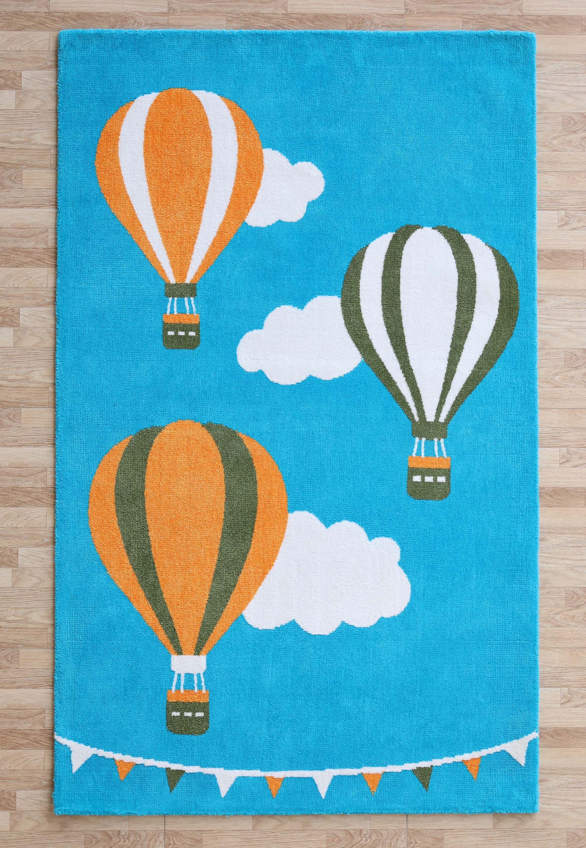 The RAMSHA HOME Kids Play Rug with Clouds & Balloons (CMN 101, 200x300 cm) features blue, orange, green balloons, fluffy clouds, and colorful pennant flags—perfect for brightening up any wooden-floored nursery or kids’ room.