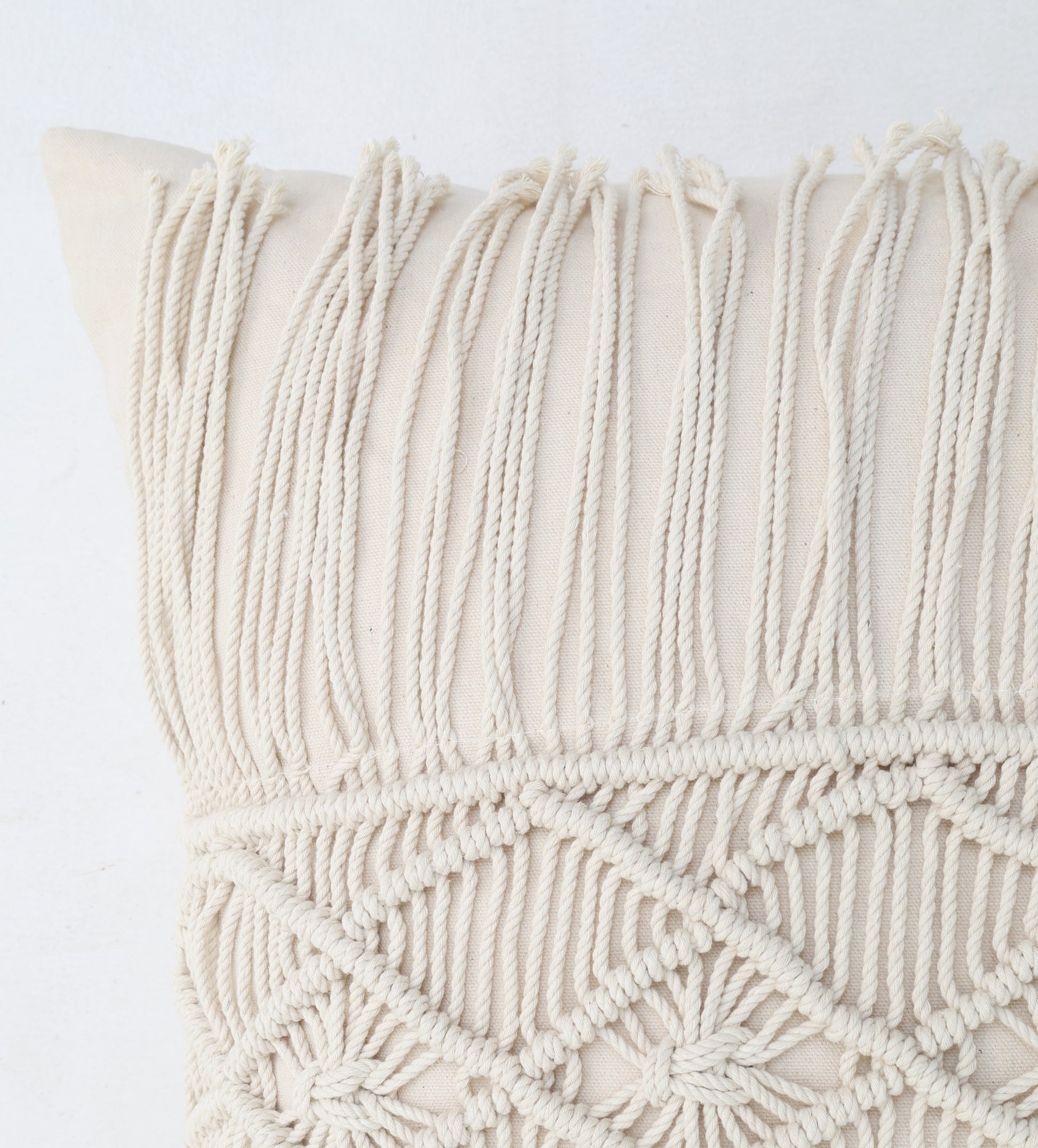 Close-up of the Ramsha Home Natural Color Jute Cushion with Filler (CS 307, 45x45cm), showcasing intricate knotted patterns and long fringe, perfect for events or bedrooms. Set against a plain white background.