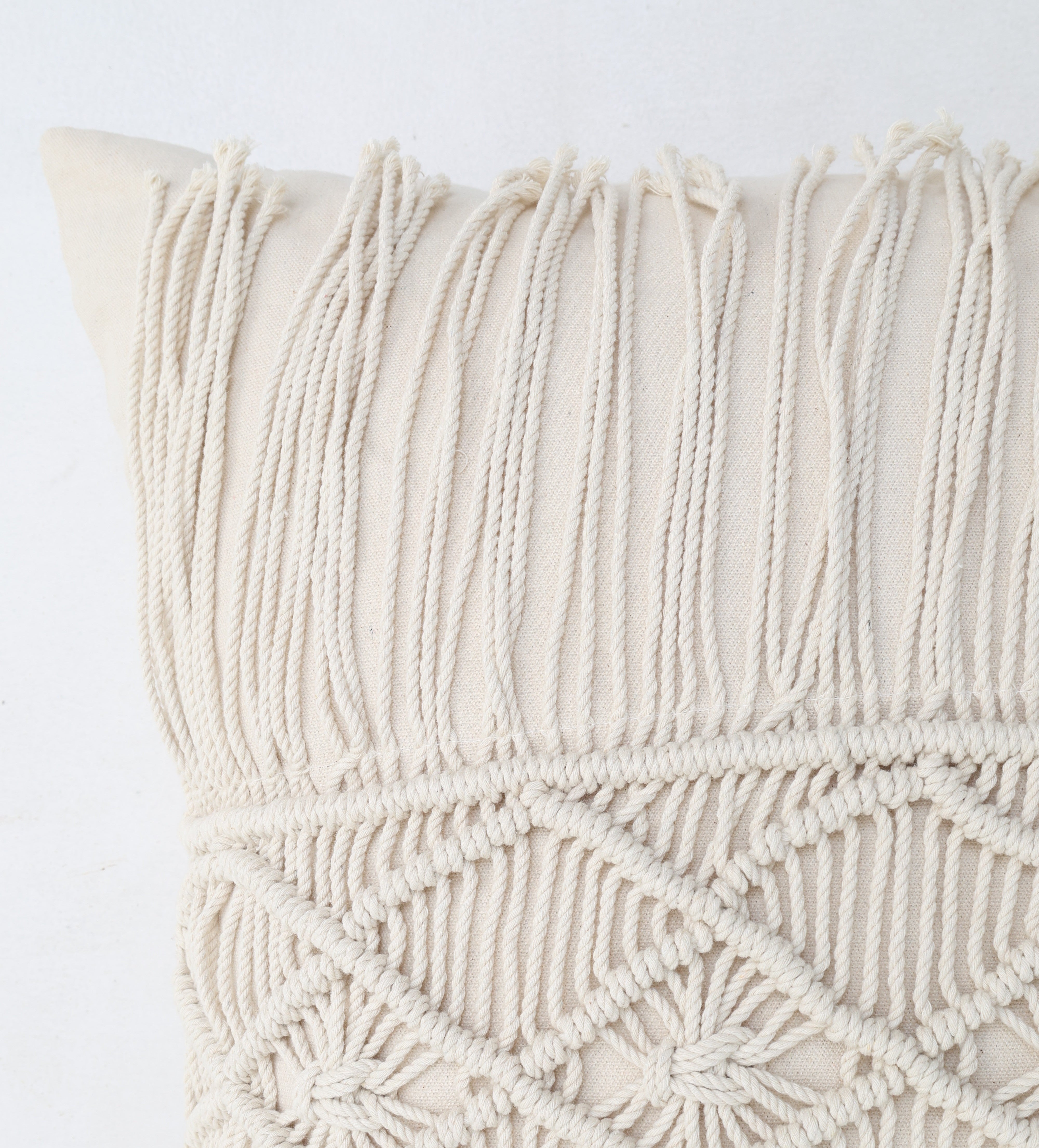 Close-up of the Ramsha Home Natural Color Jute Cushion with Filler (CS 307, 45x45cm), showcasing intricate knotted patterns and long fringe, perfect for events or bedrooms. Set against a plain white background.
