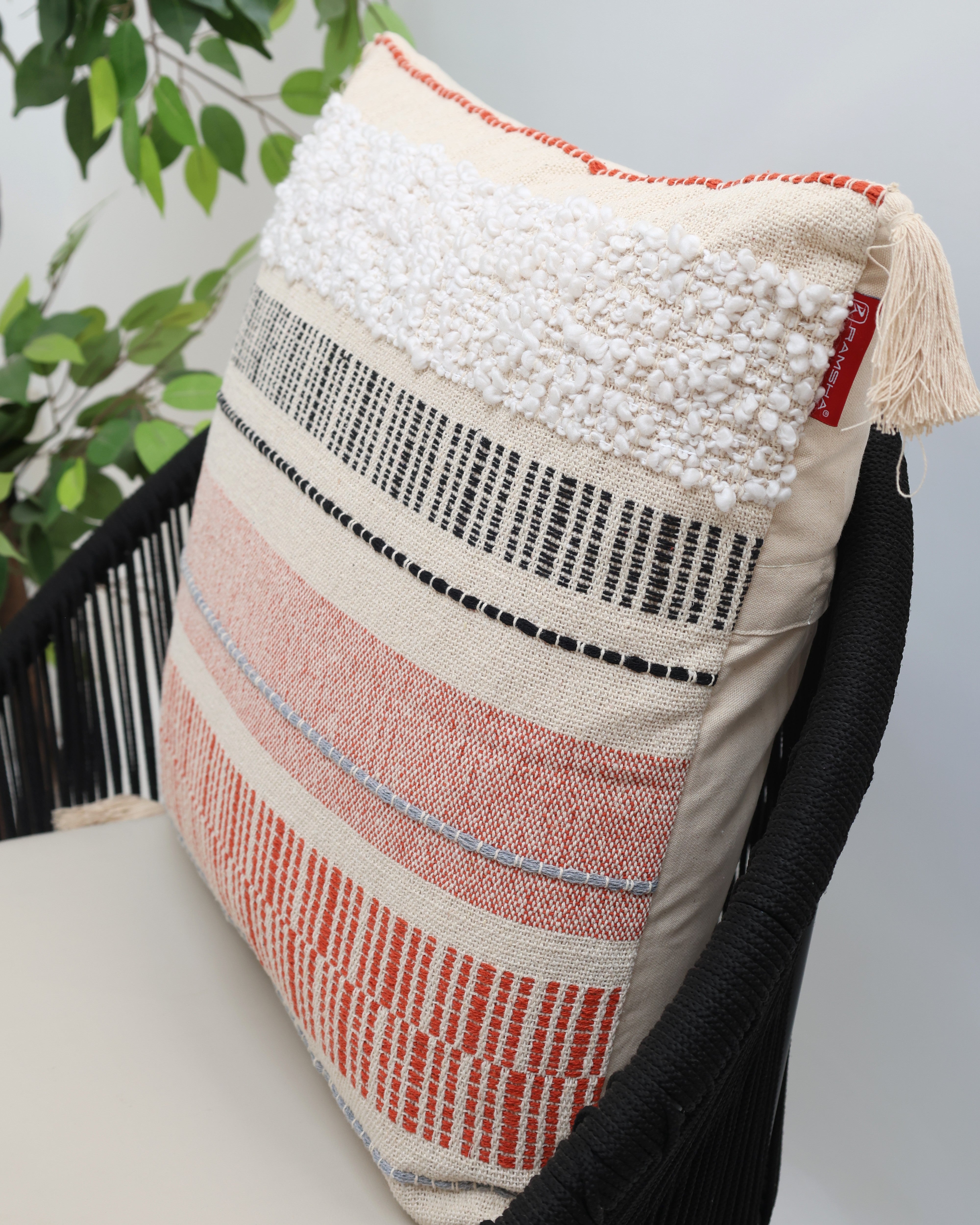 The Cream Color Home Decor Cushion - CS 314 A by Ramsha Home adds elegance with its textured white, black, and orange patterns—an ideal accent for your space from a luxury UAE home furnishings brand.